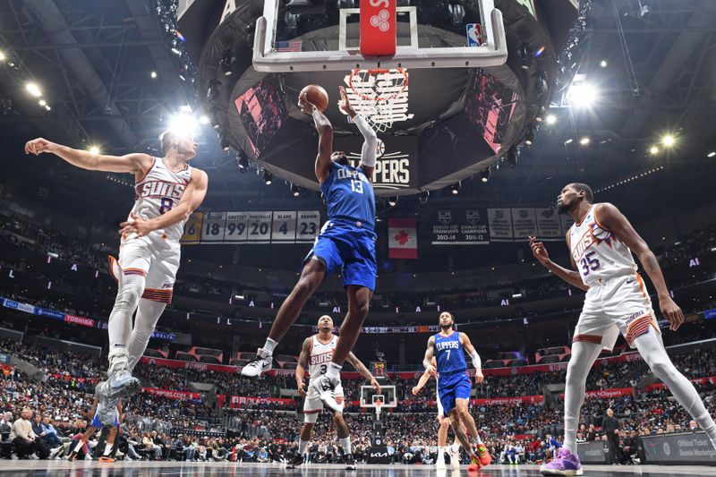 LOS ANGELES, CA - JANUARY 8: Paul George #13 of the LA Clippers drives to the basket during the game against the Phoenix Suns on January 8, 2024 at Crypto.Com Arena in Los Angeles, California. NOTE TO USER: User expressly acknowledges and agrees that, by downloading and/or using this Photograph, user is consenting to the terms and conditions of the Getty Images License Agreement. Mandatory Copyright Notice: Copyright 2024 NBAE (Photo by Andrew D. Bernstein/NBAE via Getty Images)