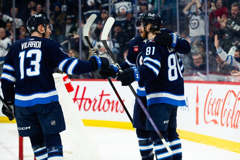 Feb 20, 2024; Winnipeg, Manitoba, CAN; Winnipeg Jets forward Kyle Connor (81) is congratulated by his team mates on his goal against the Minnesota Wild during the second period at Canada Life Centre. Mandatory Credit: Terrence Lee-USA TODAY Sports