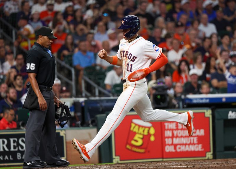 Jun 10, 2025; Houston, Texas, USA; Houston Astros right fielder Cam Smith (11) scores on a sacrifice fly ball against the Chicago White Sox in the third inning at Daikin Park. Mandatory Credit: Thomas Shea-Imagn Images