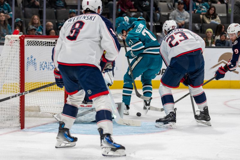 Nov 5, 2024; San Jose, California, USA;  San Jose Sharks center Nico Sturm (7) attempts to shoot the puck against Columbus Blue Jackets center Sean Monahan (23) during the second period at SAP Center at San Jose. Mandatory Credit: Neville E. Guard-Imagn Images