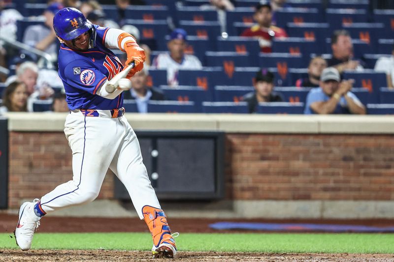 Jun 26, 2024; New York City, New York, USA;  New York Mets catcher Francisco Alvarez (4) hits an RBI single in the sixth inning against the New York Yankees at Citi Field. Mandatory Credit: Wendell Cruz-USA TODAY Sports