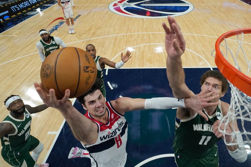 WASHINGTON, DC - APRIL 02: Deni Avdija #8 of the Washington Wizards goes up for a shot against Brook Lopez #11 of the Milwaukee Bucks during the first half at Capital One Arena on April 02, 2024 in Washington, DC. NOTE TO USER: User expressly acknowledges and agrees that, by downloading and or using this photograph, User is consenting to the terms and conditions of the Getty Images License Agreement. (Photo by Jess Rapfogel/Getty Images)