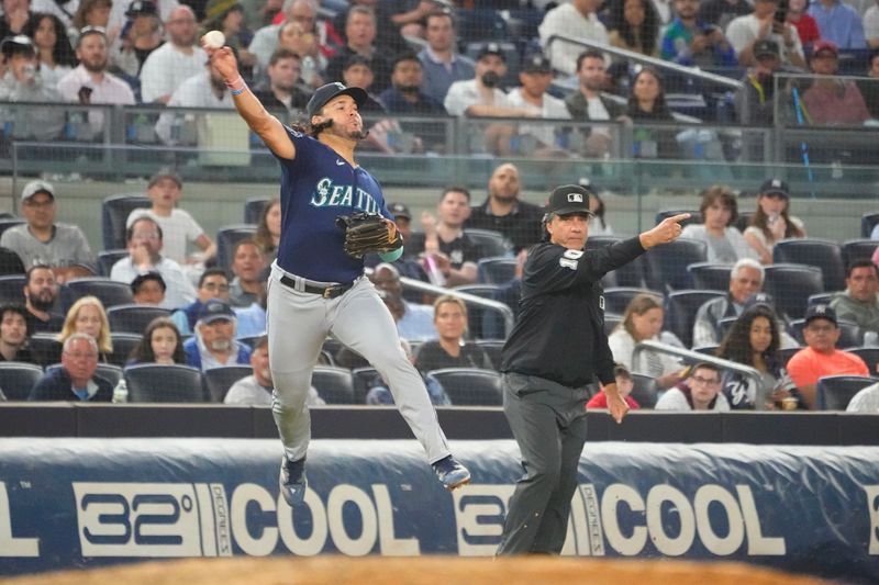 Jun 22, 2023; Bronx, New York, USA; Seattle Mariners third baseman Eugenio Suarez (28) throws out a runner at second base after fielding a ground ball hit by New York Yankees third baseman Josh Donaldson (not pictured) during the fourth inning at Yankee Stadium. Mandatory Credit: Gregory Fisher-USA TODAY Sports