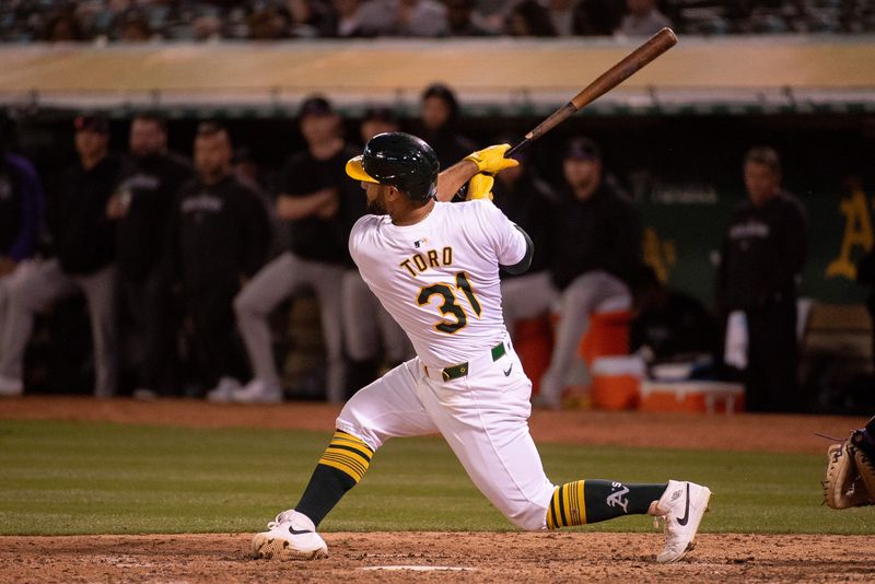 May 21, 2024; Oakland, California, USA; Oakland Athletics second base Abraham Toro (31) hits a home run against the Colorado Rockies during the eighth inning at Oakland-Alameda County Coliseum. Mandatory Credit: Ed Szczepanski-USA TODAY Sports