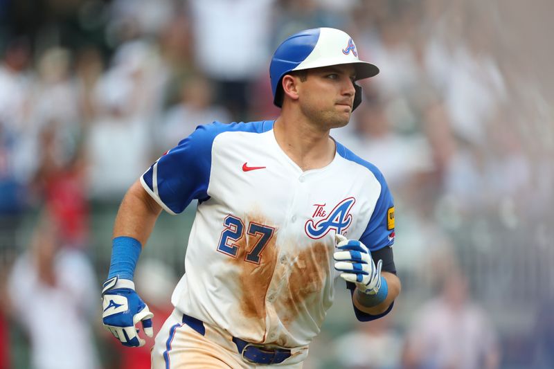 Jun 15, 2024; Cumberland, Georgia, USA; Atlanta Braves third baseman Austin Riley (27) hits a home run against the Tampa Bay Rays during the seventh inning at Truist Park. Mandatory Credit: Mady Mertens-USA TODAY Sports