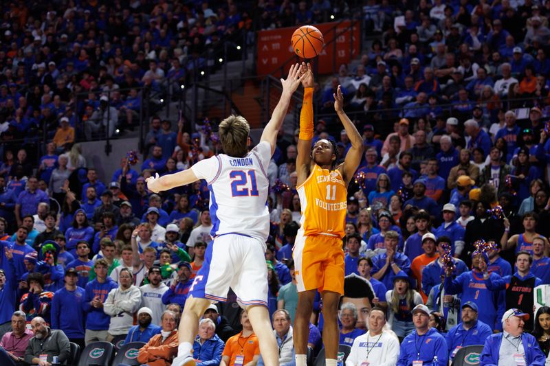 Jan 7, 2025; Gainesville, Florida, USA; Florida Gators forward Alex Condon (21) attempts to block a shot from Tennessee Volunteers guard Jordan Gainey (11) during the first half at Exactech Arena at the Stephen C. O'Connell Center. Mandatory Credit: Matt Pendleton-Imagn Images