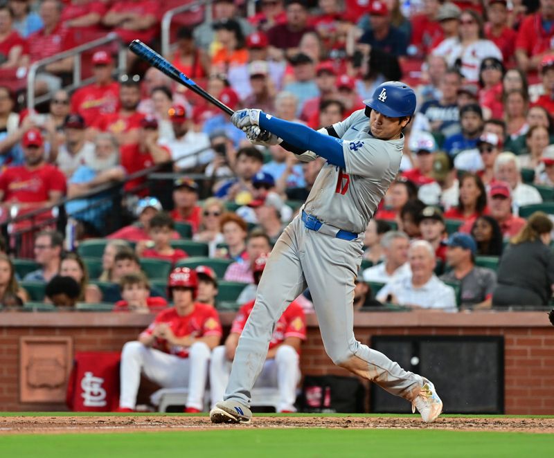 Aug 17, 2024; St. Louis, Missouri, USA;  Los Angeles Dodgers designated hitter Shohei Ohtani (17) hits a solo home run against the St. Louis Cardinals in the fifth inning at Busch Stadium. Mandatory Credit: Tim Vizer-USA TODAY Sports