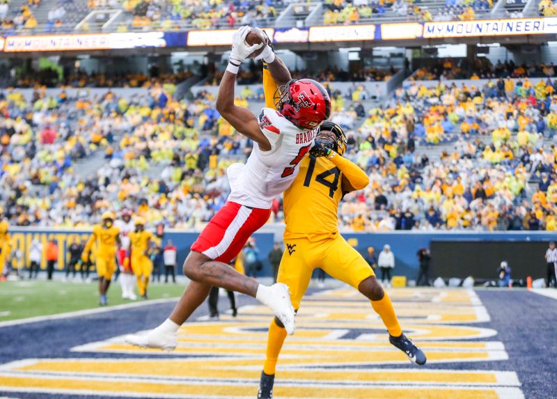 Sep 23, 2023; Morgantown, West Virginia, USA; Texas Tech Red Raiders wide receiver Jerand Bradley (9) catches a pass for a touchdown over West Virginia Mountaineers cornerback Malachi Ruffin (14) during the fourth quarter at Mountaineer Field at Milan Puskar Stadium. Mandatory Credit: Ben Queen-USA TODAY Sports