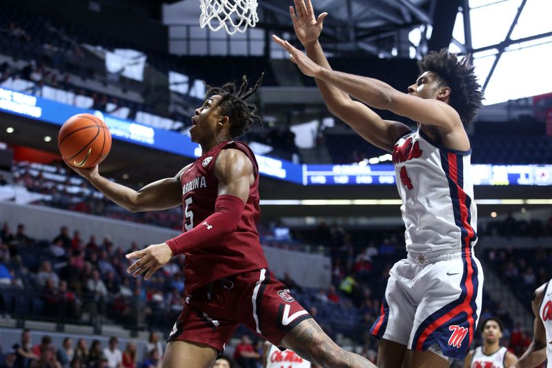 Feb 11, 2023; Oxford, Mississippi, USA; South Carolina Gamecocks guard Meechie Johnson (5) drives to the basket as Mississippi Rebels forward Jaemyn Brakefield (4) defends during the first half at The Sandy and John Black Pavilion at Ole Miss. Mandatory Credit: Petre Thomas-USA TODAY Sports