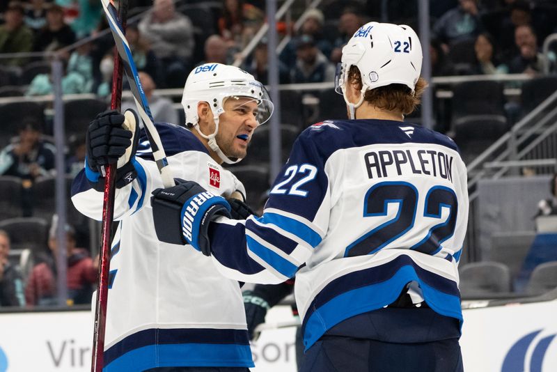 Oct 24, 2024; Seattle, Washington, USA;  Winnipeg Jets forward Nino Niederreiter (62), left, and forward Mason Appleton (22) celebrate a goal during the second period against the Seattle Kraken at Climate Pledge Arena. Mandatory Credit: Stephen Brashear-Imagn Images