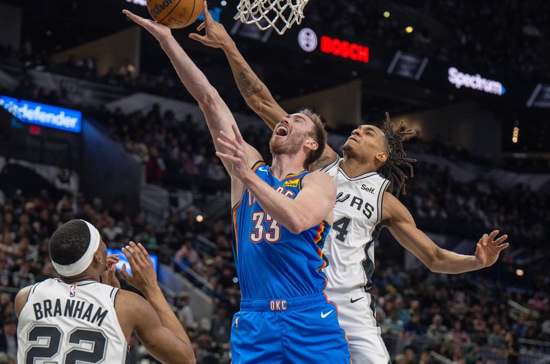 SAN ANTONIO, TX - FEBRUARY 29: Forward Gordon Hayward #33 of the Oklahoma City Thunder shot is blocked by Devin Vassell #24 of the San Antonio Spurs during a game at Frost Bank Center on February 29, 2024 in San Antonio, Texas. NOTE TO USER: User expressly acknowledges and agrees that, by downloading and or using this Photograph, user is consenting to the terms and conditions of the Getty Images License Agreement. (Photo by Brien Aho/Getty Images)