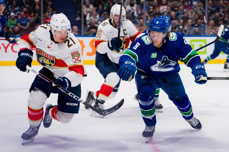 Dec 14, 2023; Vancouver, British Columbia, CAN; Florida Panthers forward Nick Cousins (21) and Vancouver Canucks forward Brock Boeser (6) skate after teh loose puck in the second period at Rogers Arena. Mandatory Credit: Bob Frid-USA TODAY Sports