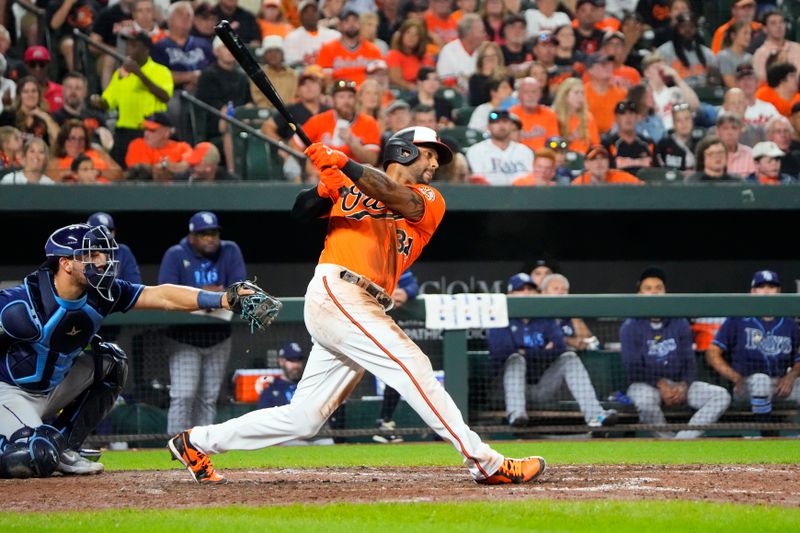 Sep 16, 2023; Baltimore, Maryland, USA; Baltimore Orioles right fielder Aaron Hicks (34) hits a single against the Tampa Bay Rays during the fifth inning at Oriole Park at Camden Yards. Mandatory Credit: Gregory Fisher-USA TODAY Sports