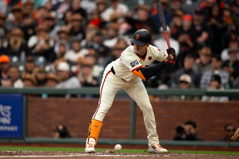 Jul 27, 2024; San Francisco, California, USA; San Francisco Giants right fielder Mike Yastrzemski (5) jumps out of the path of a wild pitch by Colorado Rockies pitcher Peter Lambert that allowed Matt Chapman to score from third base during the eighth inning at Oracle Park. Mandatory Credit: D. Ross Cameron-USA TODAY Sports