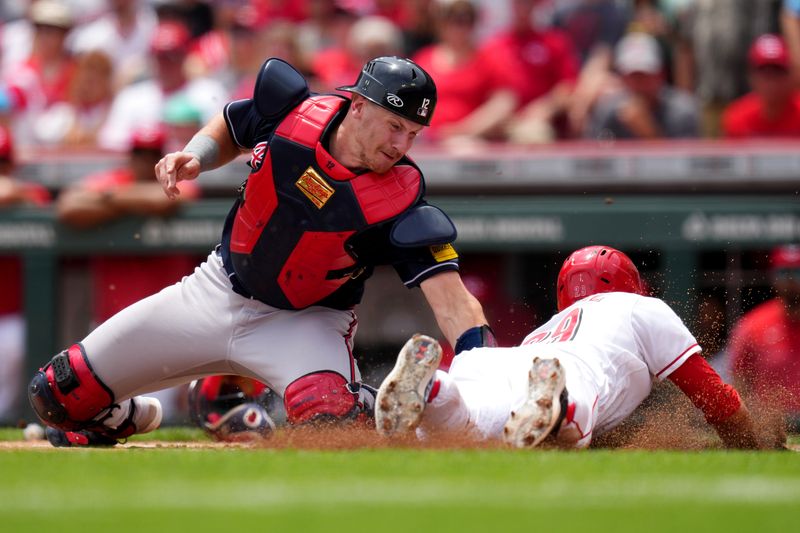 Jun 25, 2023; Cincinnati, Ohio, USA; Atlanta Braves catcher Sean Murphy (12) tags out Cincinnati Reds center fielder TJ Friedl (29) at home plate in the first inning of a baseball game at Great American Ball Park. Mandatory Credit: Kareem Elgazzar-USA TODAY Sports