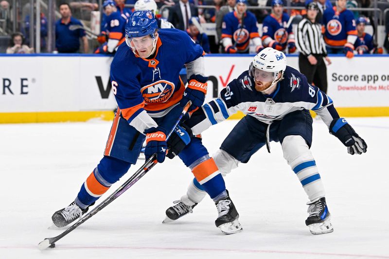 Mar 23, 2024; Elmont, New York, USA;  New York Islanders defenseman Ryan Pulock (6) attempts to clear the puck defended by Winnipeg Jets left wing Kyle Connor (81) during the first period at UBS Arena. Mandatory Credit: Dennis Schneidler-USA TODAY Sports