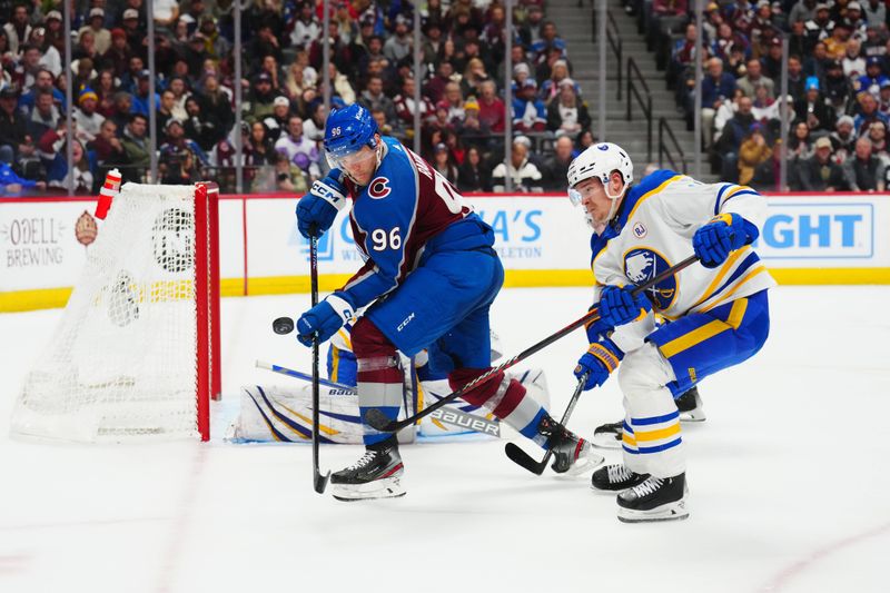 Dec 13, 2023; Denver, Colorado, USA; Colorado Avalanche right wing Mikko Rantanen (96) and Buffalo Sabres defenseman Henri Jokiharju (10) battle for the puck in the second period at Ball Arena. Mandatory Credit: Ron Chenoy-USA TODAY Sports