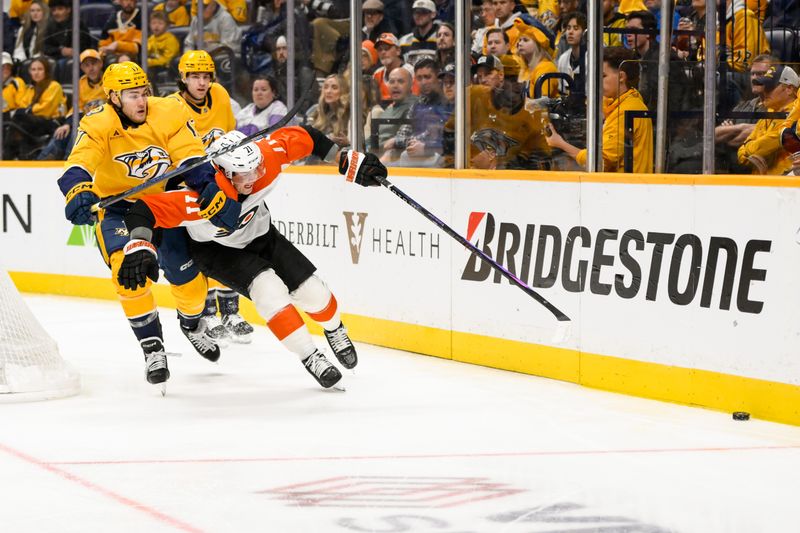 Nov 27, 2024; Nashville, Tennessee, USA;  Nashville Predators center Mark Jankowski (17) and Philadelphia Flyers right wing Tyson Foerster (71) battle for the puck during the first period at Bridgestone Arena. Mandatory Credit: Steve Roberts-Imagn Images