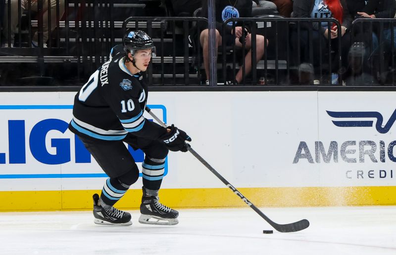 Oct 24, 2024; Salt Lake City, Utah, USA; Utah Hockey Club defenseman Maveric Lamoureux (10) skates with the puck against the Colorado Avalanche during the third period at Delta Center. Mandatory Credit: Rob Gray-Imagn Images