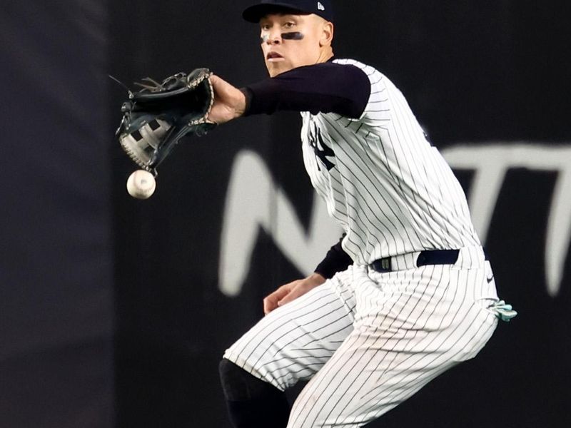 Oct 30, 2024; New York, New York, USA; New York Yankees outfielder Aaron Judge (99) makes a fielding error during the fifth inning against the Los Angeles Dodgers in game five of the 2024 MLB World Series at Yankee Stadium. Mandatory Credit: Vincent Carchietta-Imagn Images