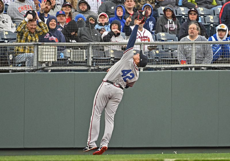 Apr 15, 2023; Kansas City, Missouri, USA;  Atlanta Braves third baseman Austin Riley (27) catches the ball in foul territory during the third inning against the Kansas City Royals at Kauffman Stadium. Mandatory Credit: Peter Aiken-USA TODAY Sports