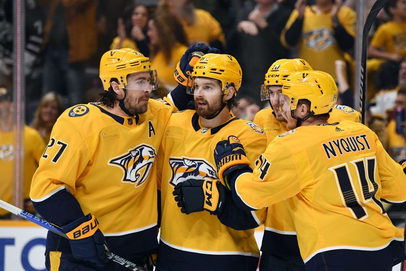 Feb 10, 2024; Nashville, Tennessee, USA; Nashville Predators center Tommy Novak (82) is congratulated by teammates after a goal during the third period against the Arizona Coyotes at Bridgestone Arena. Mandatory Credit: Christopher Hanewinckel-USA TODAY Sports