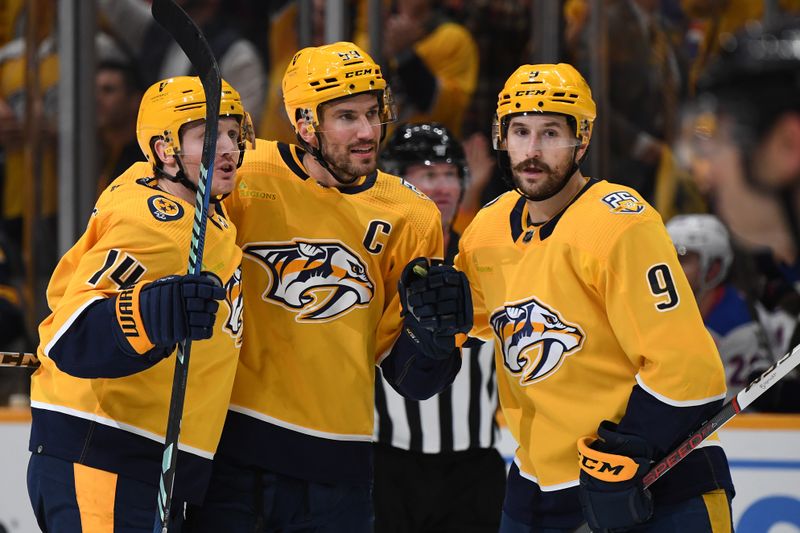 Dec 2, 2023; Nashville, Tennessee, USA; Nashville Predators defenseman Roman Josi (59) center Gustav Nyquist (14) and left wing Filip Forsberg (9) celebrate after a goal against the New York Rangers during the first period at Bridgestone Arena. Mandatory Credit: Christopher Hanewinckel-USA TODAY Sports