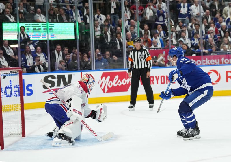 Oct 11, 2023; Toronto, Ontario, CAN; Toronto Maple Leafs right wing Mitchell Marner (16) scores the winning goal in the shoutout against the Montreal Canadiens at Scotiabank Arena. Mandatory Credit: Nick Turchiaro-USA TODAY Sports