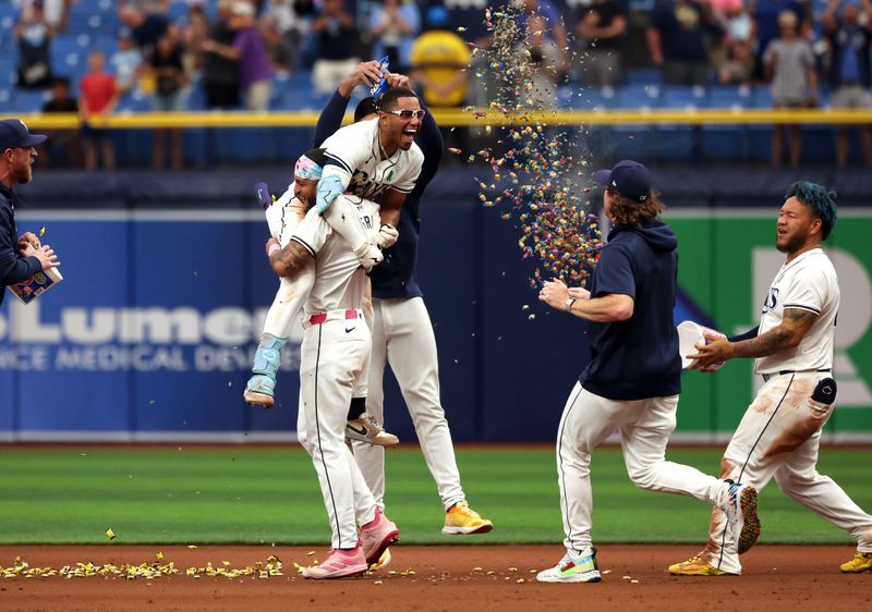 May 30, 2024; St. Petersburg, Florida, USA; Tampa Bay Rays outfielder Richie Palacios (1) celebrates with outfielder Jose Siri (22) and teammates after hitting a walk off RBI single against the Oakland Athletics during the eleventh inning at Tropicana Field. Mandatory Credit: Kim Klement Neitzel-USA TODAY Sports