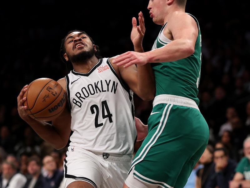 NEW YORK, NEW YORK - NOVEMBER 13: Cam Thomas #24 of the Brooklyn Nets drives agianst Payton Pritchard #11 of the Boston Celtics during the first half at Barclays Center on November 13, 2024 in New York City. NOTE TO USER: User expressly acknowledges and agrees that, by downloading and or using this photograph, User is consenting to the terms and conditions of the Getty Images License Agreement.  (Photo by Sarah Stier/Getty Images)