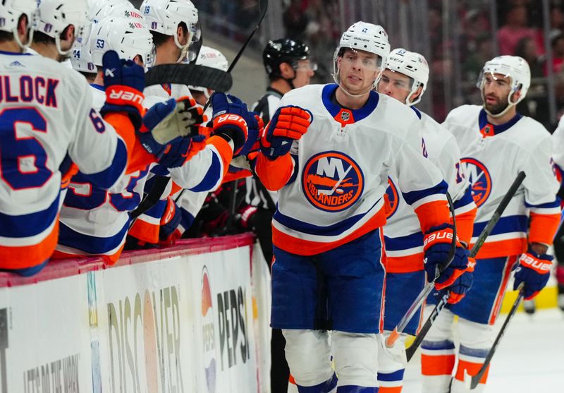 Apr 30, 2024; Raleigh, North Carolina, USA; New York Islanders defenseman Mike Reilly (2) is congratulated after his goal against the Carolina Hurricanes during the first period in game five of the first round of the 2024 Stanley Cup Playoffs at PNC Arena. Mandatory Credit: James Guillory-USA TODAY Sports