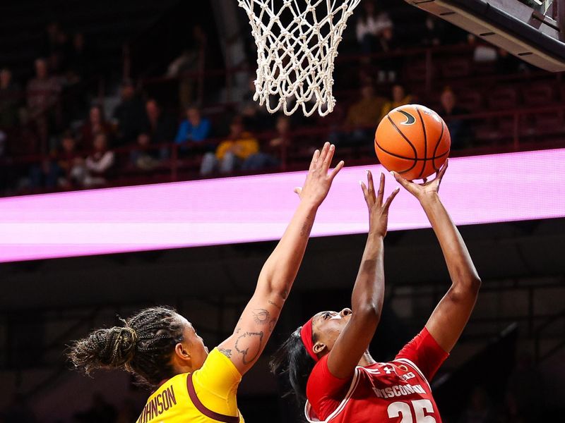 Feb 20, 2024; Minneapolis, Minnesota, USA; Wisconsin Badgers forward Serah Williams (25) shoots as Minnesota Golden Gophers forward Ayianna Johnson (1) defends during the second half at Williams Arena. Mandatory Credit: Matt Krohn-USA TODAY Sports