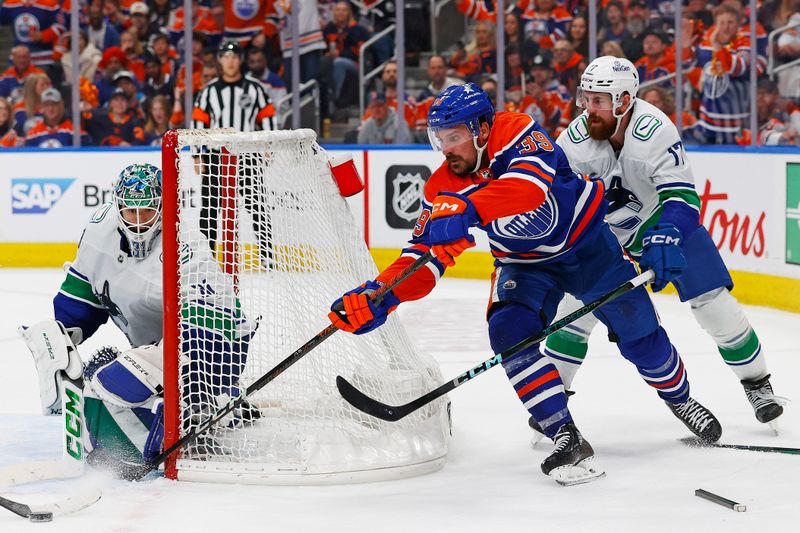 May 18, 2024; Edmonton, Alberta, CAN; Edmonton Oilers forward Sam Carrick (39) tries a wraparound on Vancouver Canucks goaltender Arturs Silovs (31) during the third period in game six of the second round of the 2024 Stanley Cup Playoffs at Rogers Place. Mandatory Credit: Perry Nelson-USA TODAY Sports