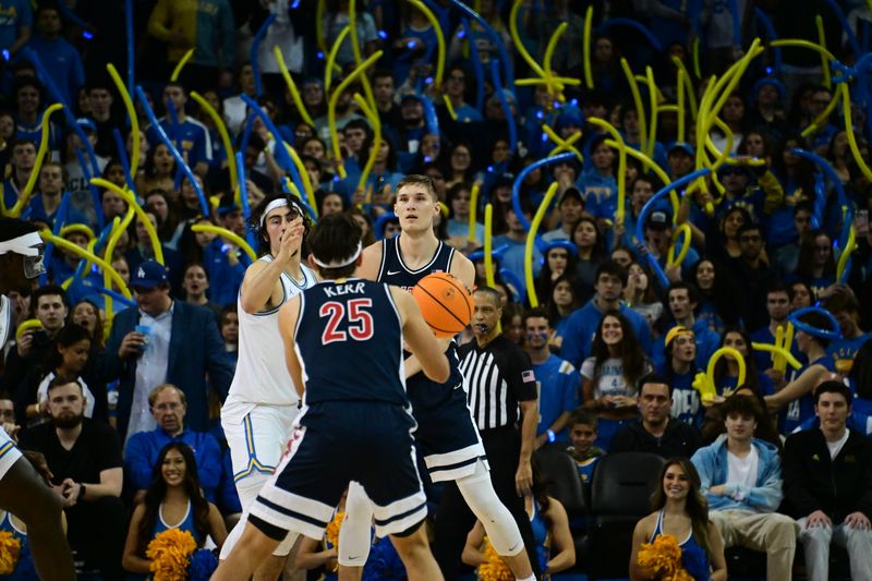 Mar 4, 2023; Los Angeles, California, USA;  Arizona Wildcats guard Kerr Kriisa (25) handles the ball as UCLA Bruins guard Jaime Jaquez Jr. (24) during the second half at Pauley Pavilion presented by Wescom. Mandatory Credit: Richard Mackson-USA TODAY Sports