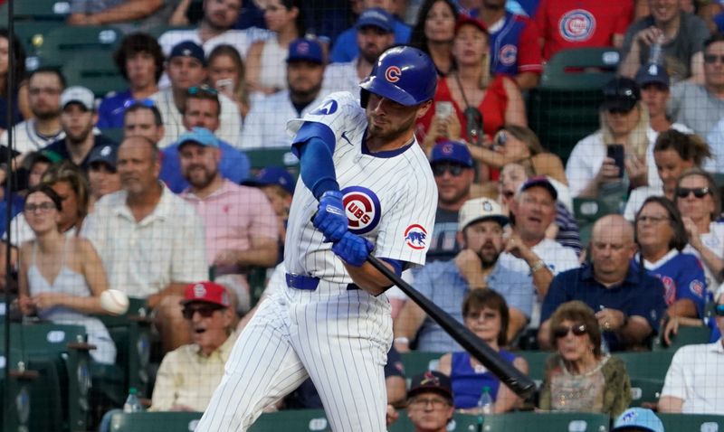 Aug 4, 2024; Chicago, Illinois, USA; Chicago Cubs first base Michael Busch (29) hits a single against the St. Louis Cardinals during the fifth inning at Wrigley Field. Mandatory Credit: David Banks-USA TODAY Sports