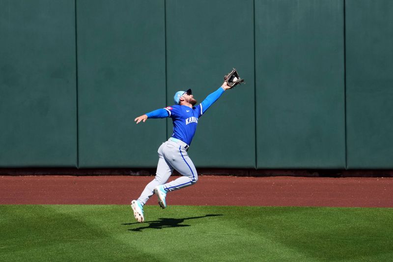 Mar 8, 2024; Surprise, Arizona, USA; Kansas City Royals center fielder Kyle Isbel (28) makes a catch against the Texas Rangers during the third inning at Surprise Stadium. Mandatory Credit: Joe Camporeale-USA TODAY Sports