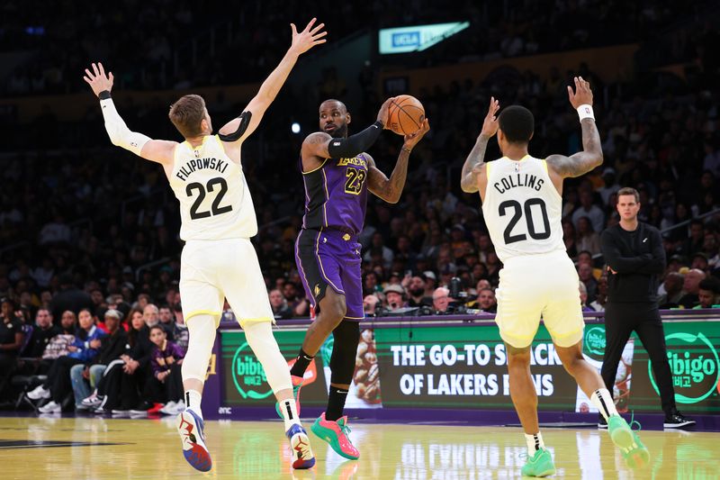 LOS ANGELES, CALIFORNIA - NOVEMBER 19: LeBron James #23 of the Los Angeles Lakers passes between Kyle Filipowski #22 and John Collins #20 of the Utah Jazz during the first quarter of the Emirates NBA Cup at Crypto.com Arena on November 19, 2024 in Los Angeles, California. NOTE TO USER: User expressly acknowledges and agrees that, by downloading and or using this photograph, User is consenting to the terms and conditions of the Getty Images License Agreement.  (Photo by Harry How/Getty Images)