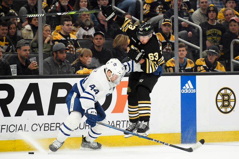 Apr 20, 2024; Boston, Massachusetts, USA; Boston Bruins left wing Brad Marchand (63) tries to skate past Toronto Maple Leafs defenseman Morgan Rielly (44) during the third period in game one of the first round of the 2024 Stanley Cup Playoffs at TD Garden. Mandatory Credit: Bob DeChiara-USA TODAY Sports