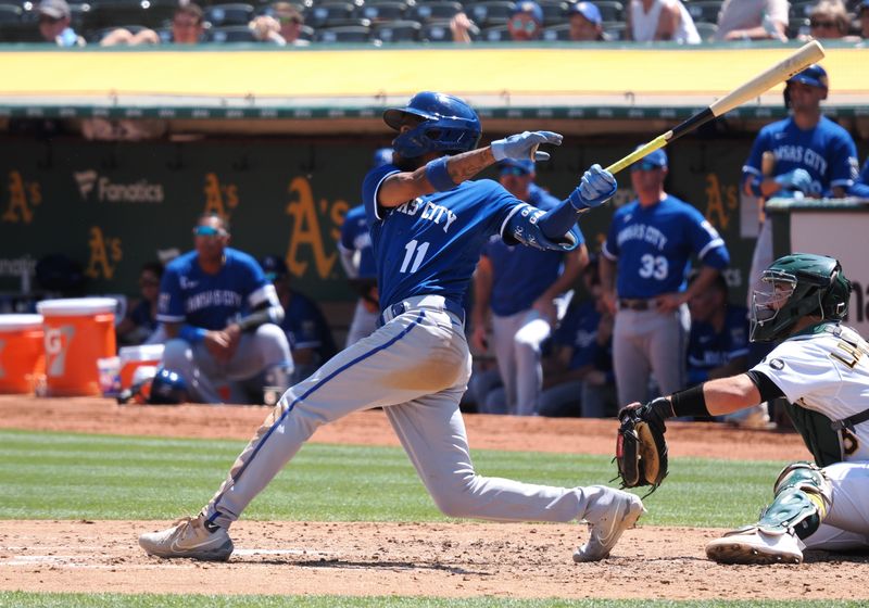 Aug 23, 2023; Oakland, California, USA; Kansas City Royals third baseman Maikel Garcia (11) hits a sacrifice fly to send in a run against the Oakland Athletics during the fourth inning at Oakland-Alameda County Coliseum. Mandatory Credit: Kelley L Cox-USA TODAY Sports