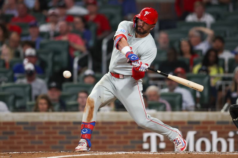 Aug 21, 2024; Atlanta, Georgia, USA; Philadelphia Phillies designated hitter Kyle Schwarber (12) drives in a run on a ground out against the Atlanta Braves in the sixth inning at Truist Park. Mandatory Credit: Brett Davis-USA TODAY Sports