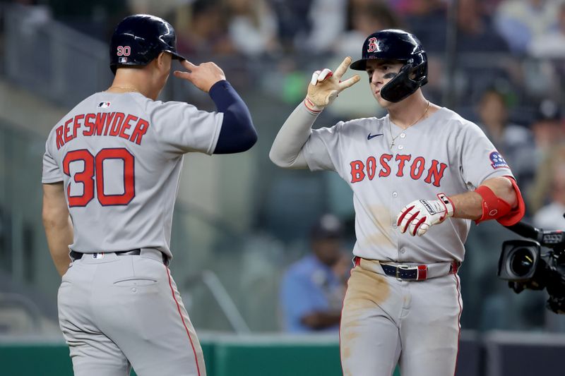 Jun 7, 2025; Bronx, New York, USA; Boston Red Sox first baseman Romy Gonzalez (23) celebrates his two run home run against the New York Yankees with right fielder Rob Refsnyder (30) during the fourth inning at Yankee Stadium. Mandatory Credit: Brad Penner-Imagn Images