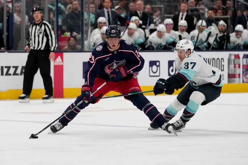 Mar 3, 2023; Columbus, Ohio, USA; Columbus Blue Jackets left wing Patrik Laine (29) skates against Seattle Kraken center Yanni Gourde (37) during the second period at Nationwide Arena. Mandatory Credit: Jason Mowry-USA TODAY Sports