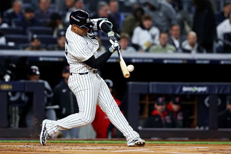 Oct 15, 2024; Bronx, New York, USA; New York Yankees second base Gleyber Torres (25) hits a double during the first inning against the Cleveland Guardians in game two of the ALCS for the 2024 MLB Playoffs at Yankee Stadium. Mandatory Credit: Wendell Cruz-Imagn Images