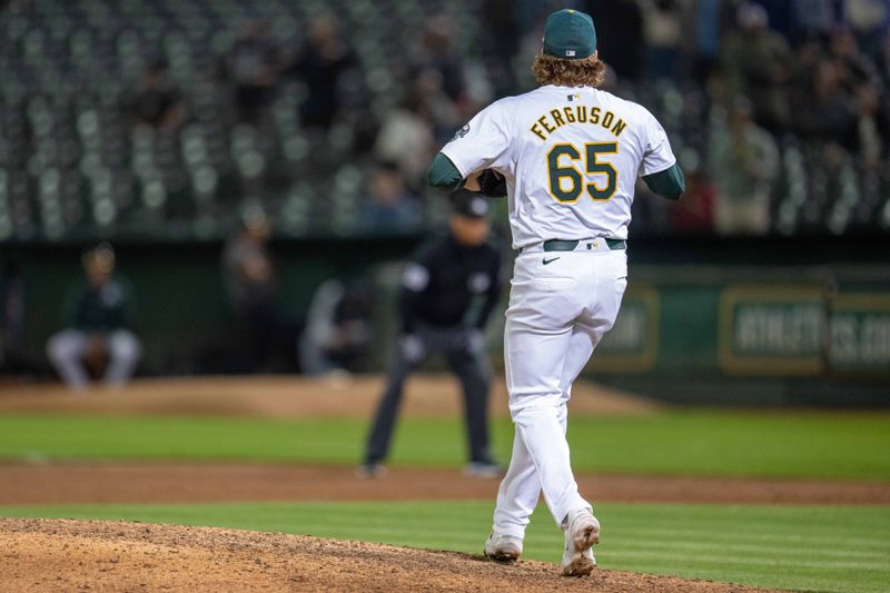 Aug 5, 2024; Oakland, California, USA;  Oakland Athletics pitcher Tyler Ferguson (65) reacts after striking out Chicago White Sox designated hitter Nick Senzel (not pictured) for the final out of the game at Oakland-Alameda County Coliseum. Mandatory Credit: Neville E. Guard-USA TODAY Sports