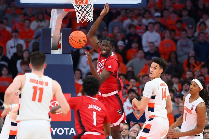 Feb 14, 2023; Syracuse, New York, USA; North Carolina State Wolfpack forward Ebenezer Dowuona (21) loses control of the ball on a drive against the Syracuse Orange during the first half at the JMA Wireless Dome. Mandatory Credit: Rich Barnes-USA TODAY Sports