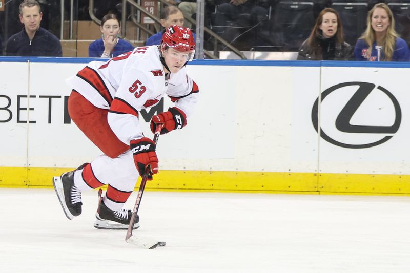 Jan 28, 2025; New York, New York, USA;  Carolina Hurricanes right wing Jackson Blake (53) controls the puck in the second period against the New York Rangers at Madison Square Garden. Mandatory Credit: Wendell Cruz-Imagn Images