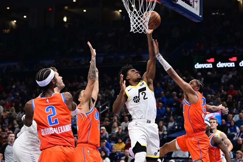 OKLAHOMA CITY, OKLAHOMA - DECEMBER 3: Collin Sexton #2 of the Utah Jazz goes up for a shot while being defended by Aaron Wiggins #21 of the Oklahoma City Thunder during the first half at Paycom Center on December 3, 2024 in Oklahoma City, Oklahoma. NOTE TO USER: User expressly acknowledges and agrees that, by downloading and or using this photograph, User is consenting to the terms and conditions of the Getty Images License Agreement. (Photo by Joshua Gateley/Getty Images)