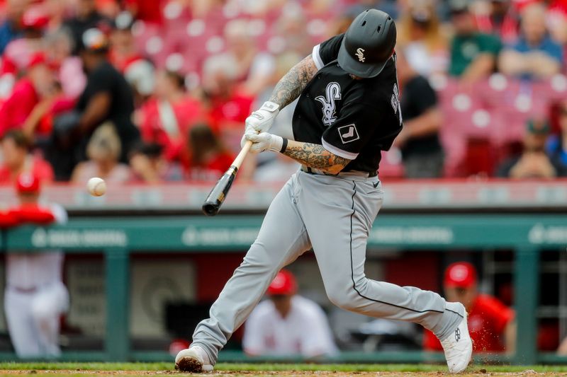 May 7, 2023; Cincinnati, Ohio, USA; Chicago White Sox designated hitter Yasmani Grandal (24) hits a RBI single in the second inning against the Cincinnati Reds at Great American Ball Park. Mandatory Credit: Katie Stratman-USA TODAY Sports