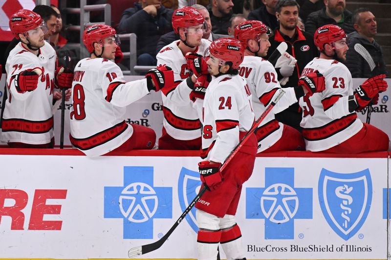 Apr 14, 2024; Chicago, Illinois, USA; Carolina Hurricanes forward Seth Jarvis (24) celebrates with the bench after scoring a power play goal in the third period against the Chicago Blackhawks at United Center. Mandatory Credit: Jamie Sabau-USA TODAY Sports