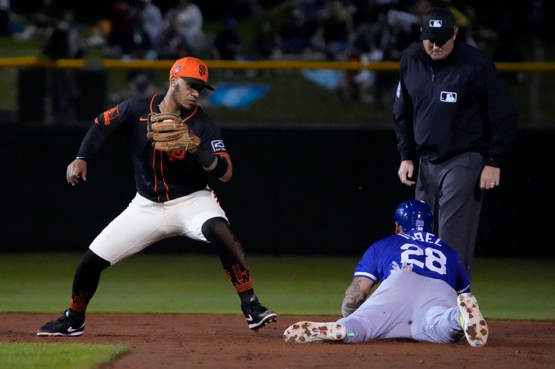 Mar 19, 2024; Scottsdale, Arizona, USA; Kansas City Royals center fielder Kyle Isbel (28) steals secondbase under the tag by San Francisco Giants second baseman Thairo Estrada (39) in the third inning at Scottsdale Stadium. Mandatory Credit: Rick Scuteri-USA TODAY Sports